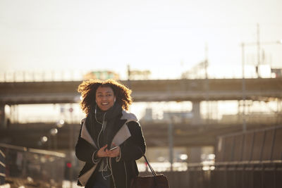 View of smiling young woman walking