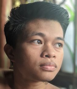 Close-up portrait of young man looking away