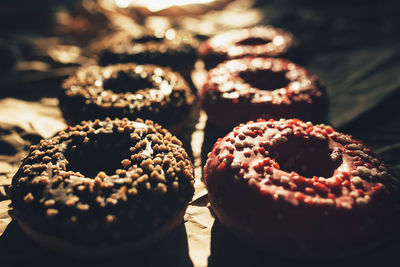 Fresh chocolate and raspberry donuts on crumpled craft paper. high quality photo