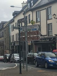 Cars on street against buildings in city