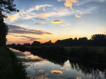 Scenic view of lake against sky during sunset