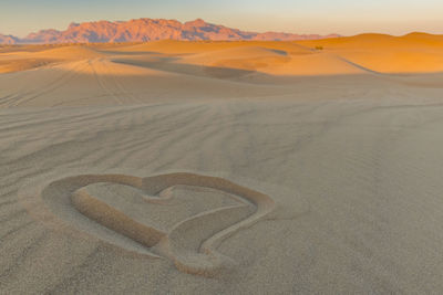 Sand dunes in desert against sky