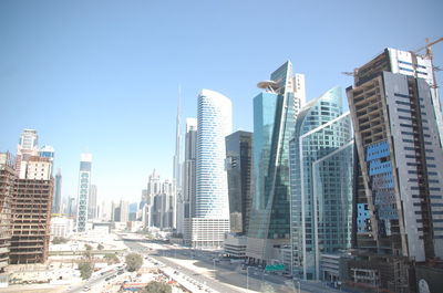 Buildings in city against clear sky