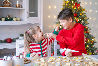 Boy playing with christmas tree at home