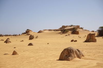 Panoramic view of desert against clear sky