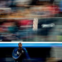 Blurred motion of man cycling on car window