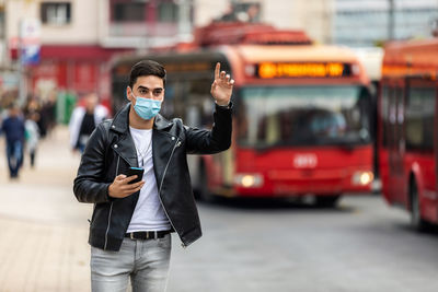 A man in a medical surgical mask in the summer city. coronavirus, illness, infection, quarantine.