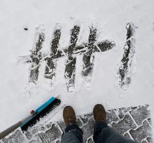 Low section of man standing on snow