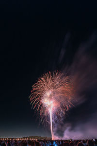 Low angle view of firework display at night