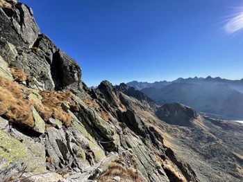 Scenic view of mountains against clear blue sky