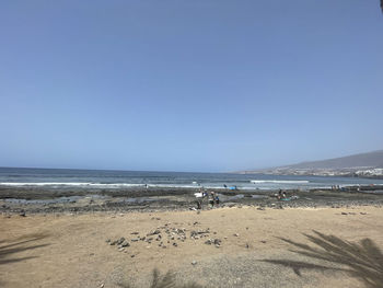 Scenic view of beach against clear sky