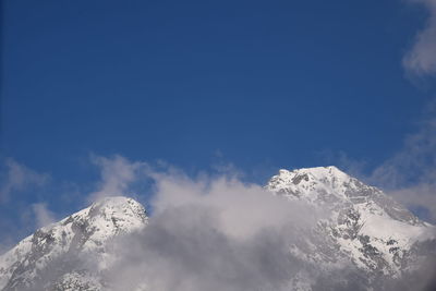 Low angle view of snowcapped mountain against sky