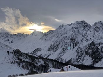 Scenic view of snow covered mountains against sky