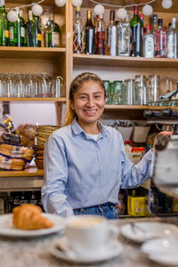 Portrait of smiling businesswoman at cafe