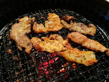 High angle view of meat on barbecue grill