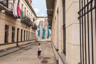 People walking on street amidst buildings in city