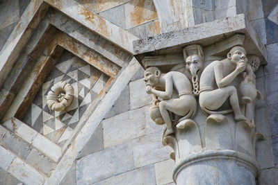 Low angle view of statue against historic building