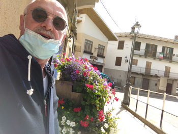 Portrait of man standing by building