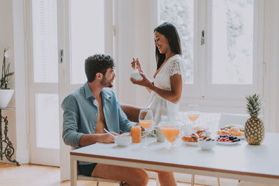 Young couple sitting on table