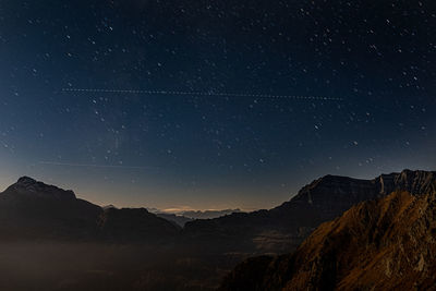 Low angle view of mountain against sky at night