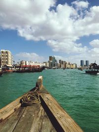 Boat in sea against buildings in city