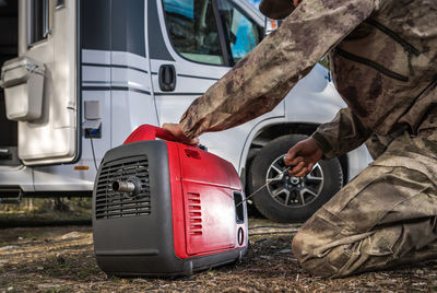 Rear view of man cleaning car