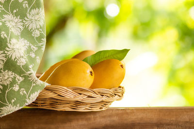 Mangoes in basket on window