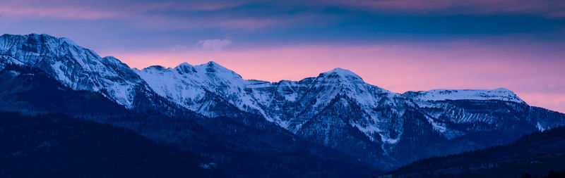 Scenic view of snowcapped mountains against sky during sunset