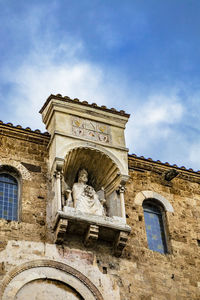 Low angle view of statue against building