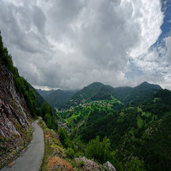 Scenic view of mountains against cloudy sky