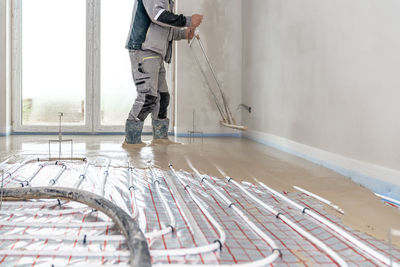 Low section of man working at construction site