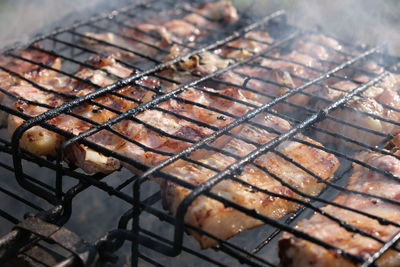 High angle view of meat on barbecue grill