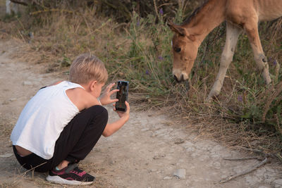 Man photographing camera on field