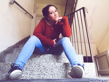 Portrait of woman sitting on staircase