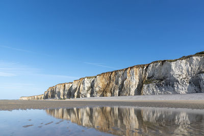 Scenic view of rock formations against blue sky