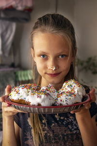 Portrait of cute girl holding camera