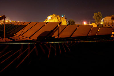 Low angle view of illuminated building against sky at night