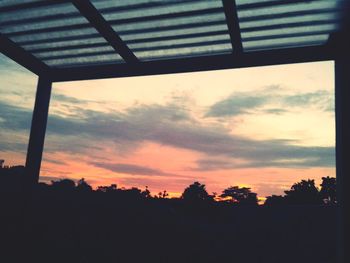 Low angle view of silhouette trees against sky