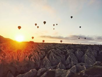 Hot air balloons flying over landscape