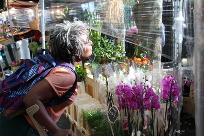 Full length of man with pink flowers