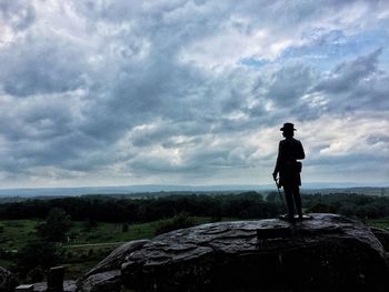 Man standing on rock looking at view