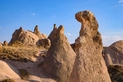 Low angle view of rock formations against sky