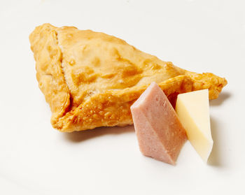 High angle view of bread in plate against white background