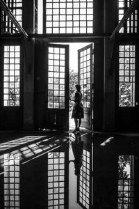 Woman walking in corridor of building