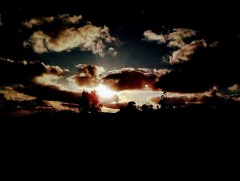 Silhouette landscape against sky at sunset