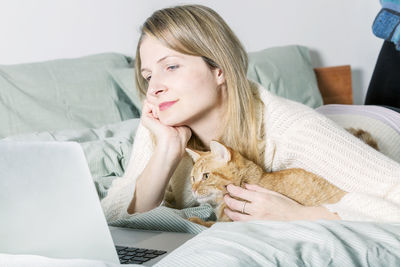 Young woman using mobile phone at home