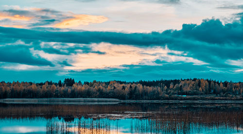 Scenic view of lake against sky at sunset