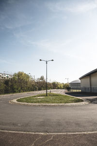 Empty road against sky in city