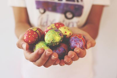 Midsection of child holding colorful easter eggs