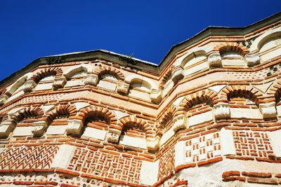 Low angle view of ornate building against clear blue sky